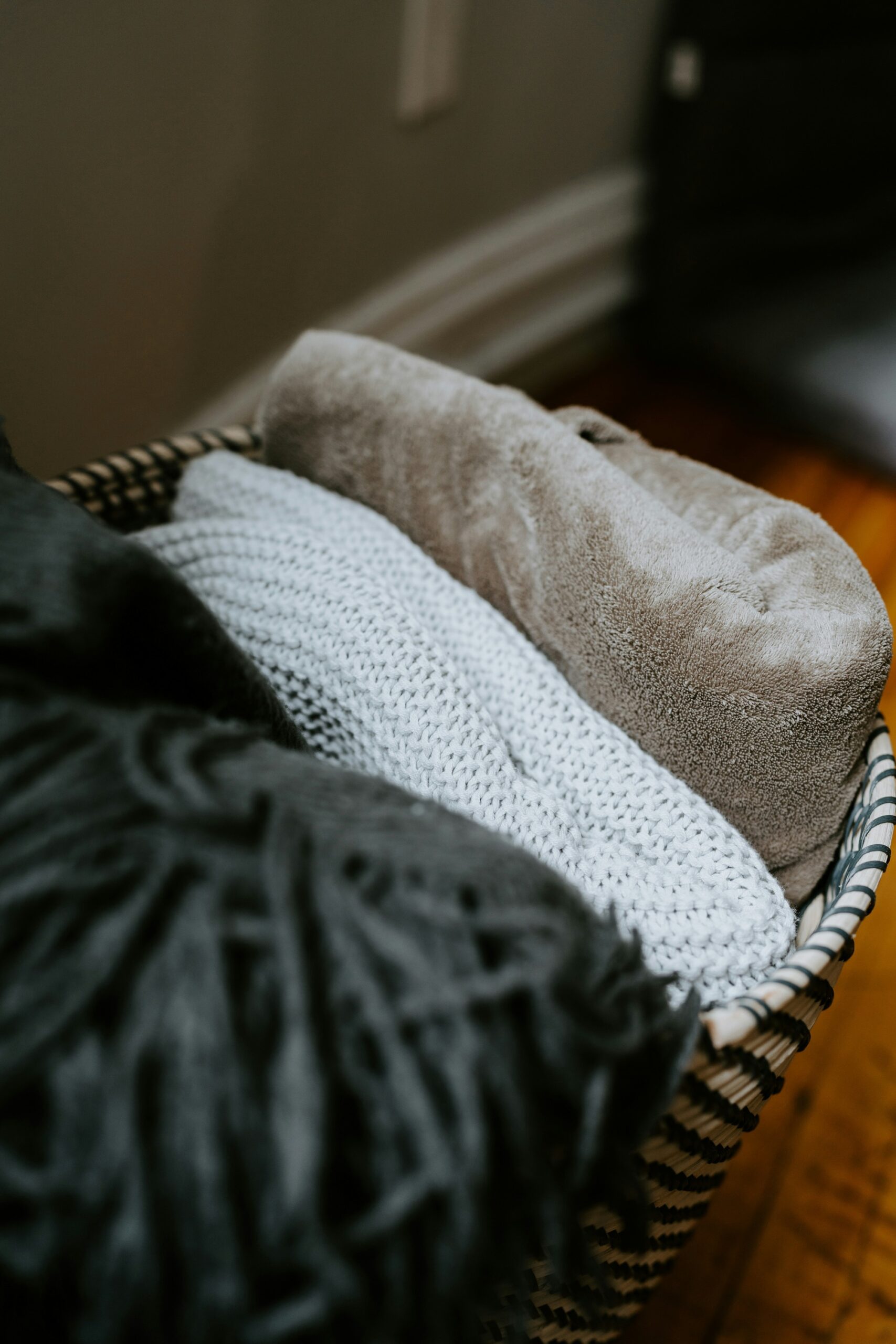 Basket with three folded blankets